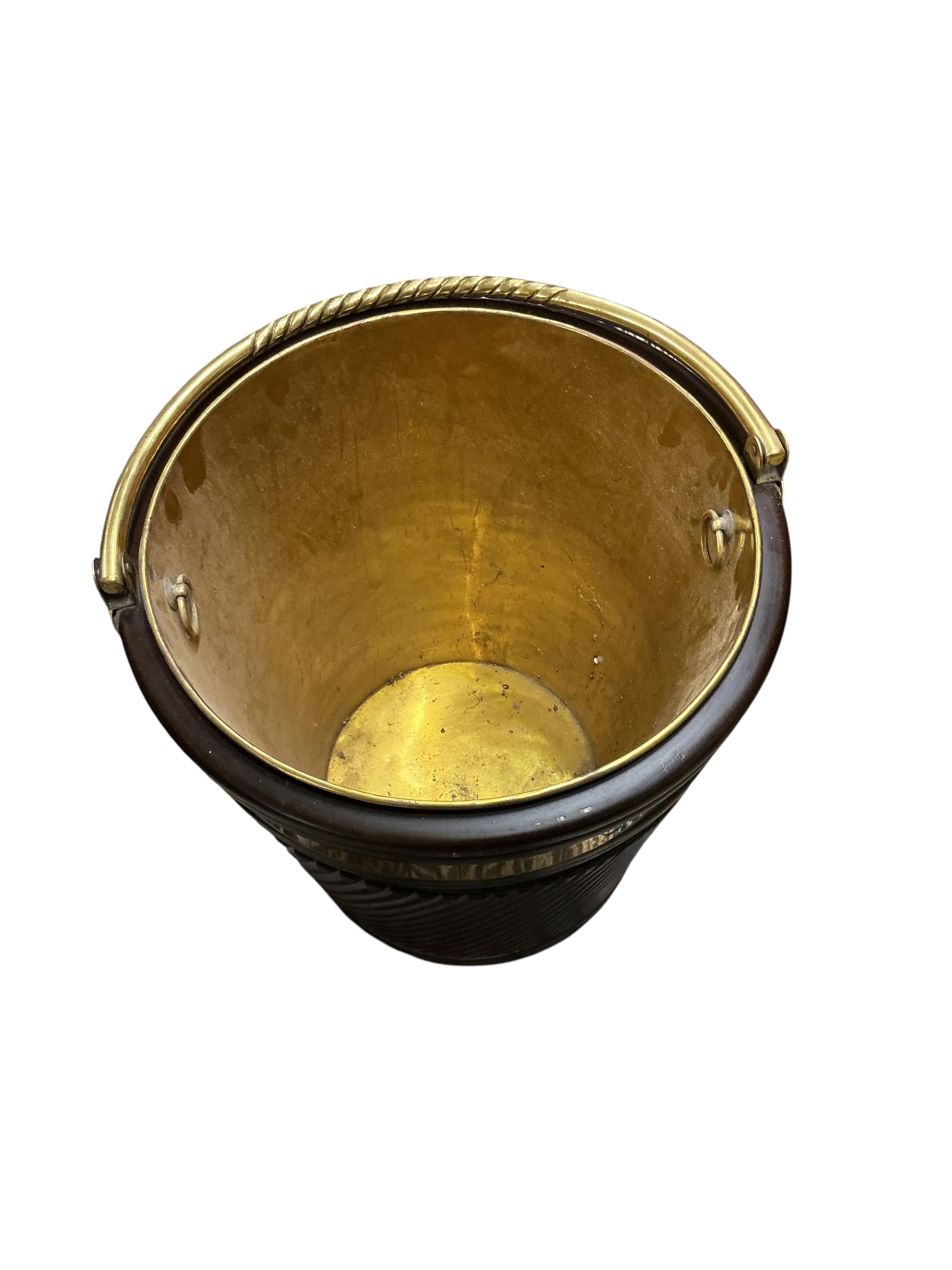 A large reproduction George III Irish style brass bound mahogany peat bucket with brass liner, diameter 46cm, height 53cm